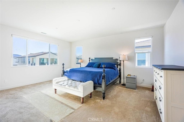 bedroom featuring baseboards and light carpet