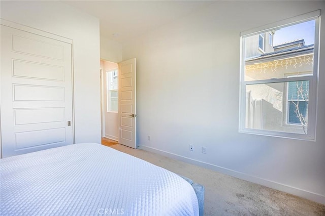 unfurnished bedroom featuring light carpet