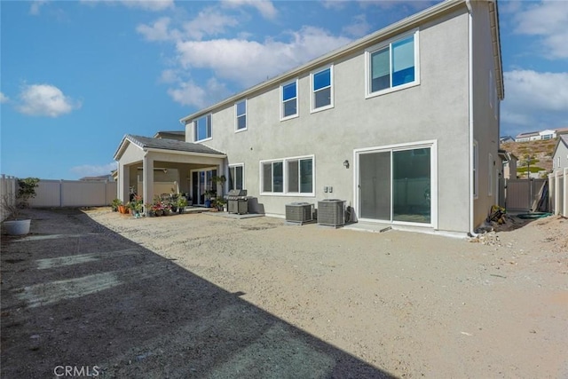 back of house with central AC unit and a patio area