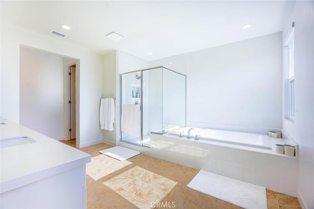 bathroom with vanity, a healthy amount of sunlight, separate shower and tub, and tile patterned flooring