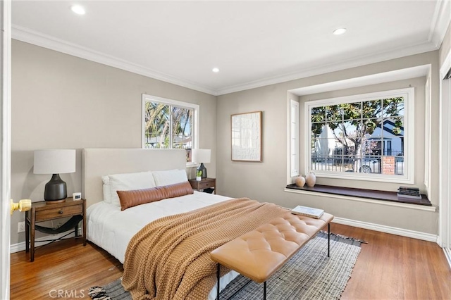 bedroom with crown molding, recessed lighting, wood finished floors, and baseboards