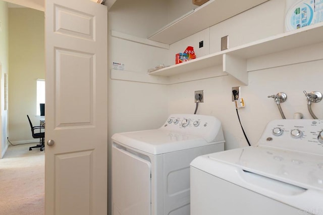 clothes washing area with washer and clothes dryer and carpet flooring