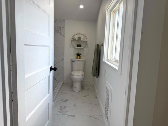 bathroom with toilet and a wealth of natural light