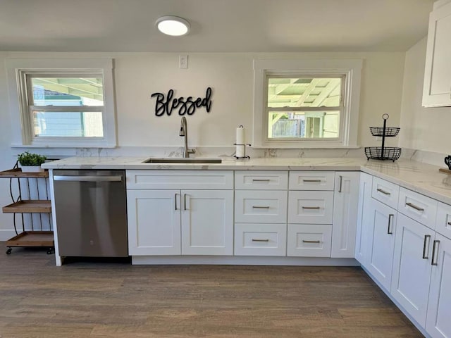 kitchen with light stone counters, dishwasher, a healthy amount of sunlight, white cabinets, and sink