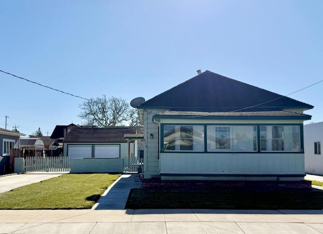 view of front of property with a garage and a front lawn