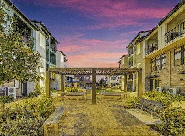 view of community with ac unit and a pergola