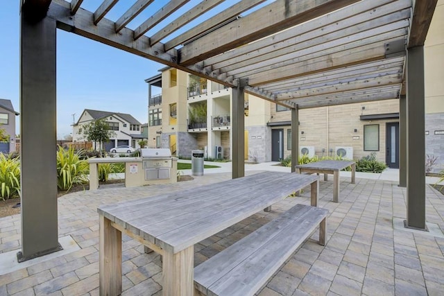 view of patio with a pergola and area for grilling