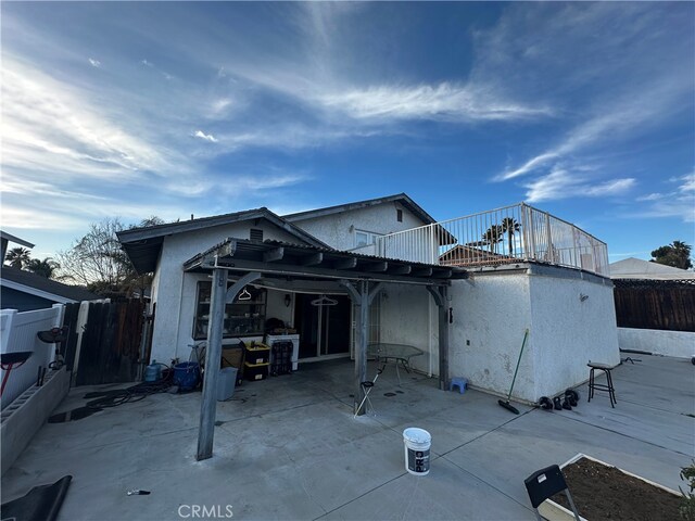 rear view of property featuring a patio area and a pergola