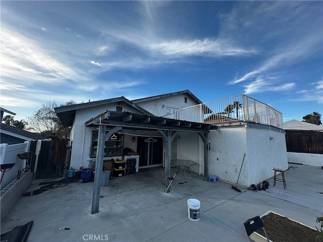 rear view of house with a pergola and a patio area