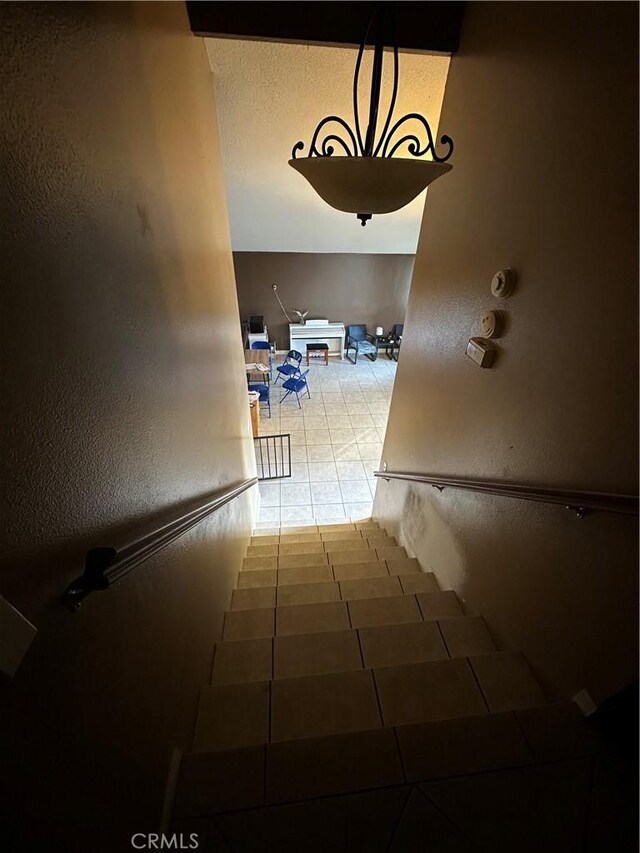 staircase with tile patterned floors