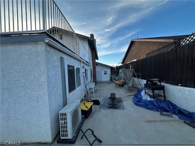 view of side of home featuring ac unit and a patio area