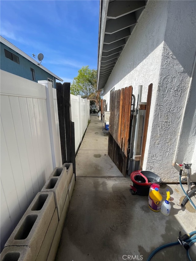 view of property exterior with fence and stucco siding