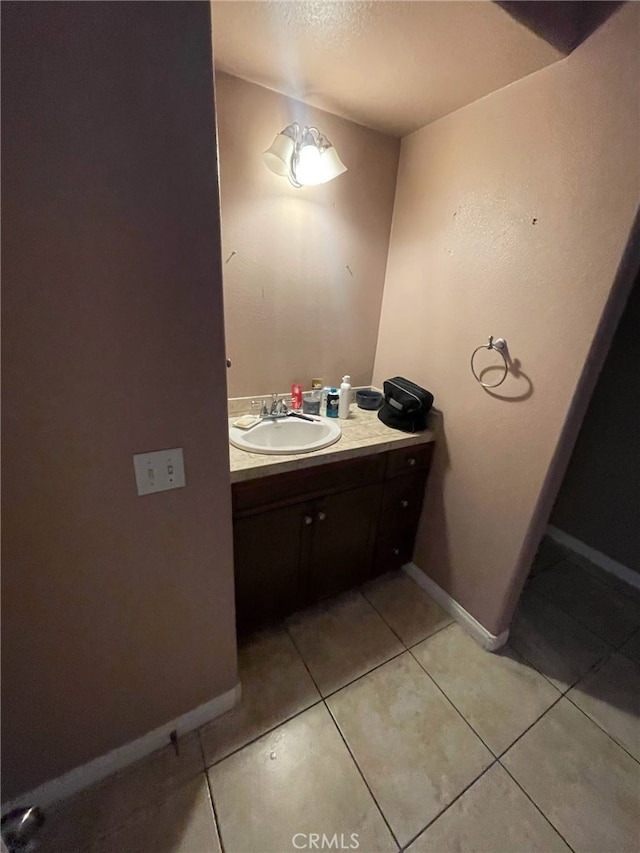 bathroom with vanity, tile patterned floors, and a textured ceiling