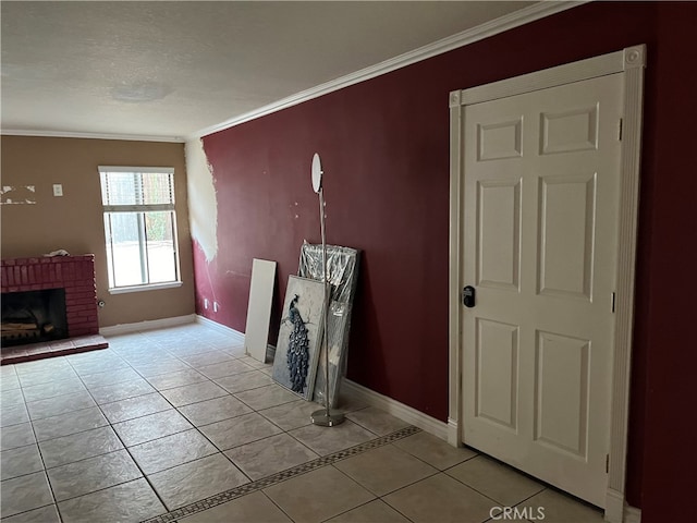 unfurnished living room with crown molding, baseboards, light tile patterned floors, and a fireplace