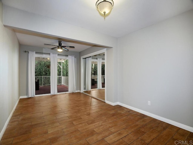 spare room with ceiling fan and wood-type flooring