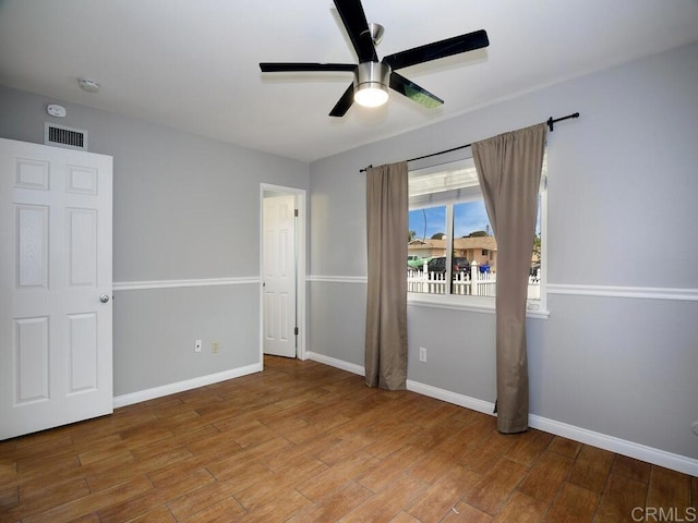 unfurnished bedroom featuring hardwood / wood-style floors and ceiling fan