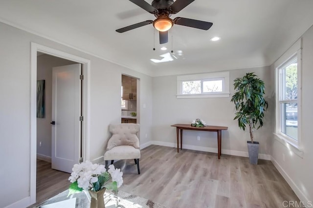 sitting room featuring ceiling fan and light hardwood / wood-style flooring