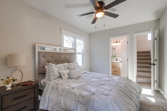 bedroom featuring ceiling fan and ensuite bathroom