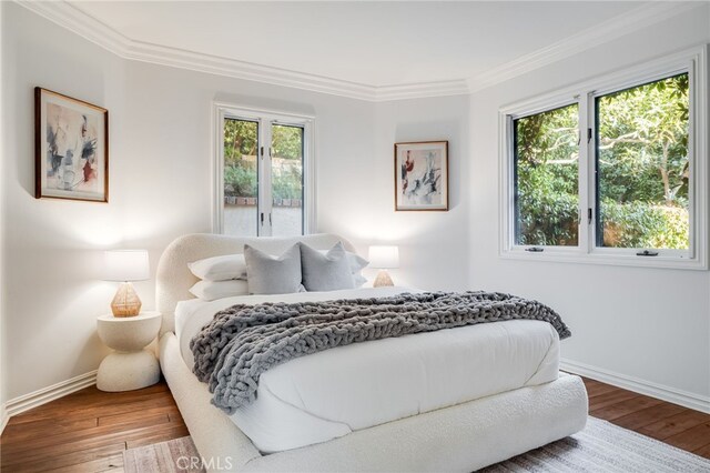 bedroom with crown molding and wood-type flooring