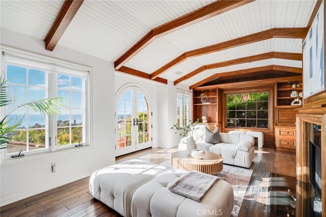 sunroom with french doors, lofted ceiling with beams, and wooden ceiling