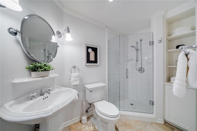 bathroom featuring sink, tile patterned flooring, an enclosed shower, toilet, and crown molding