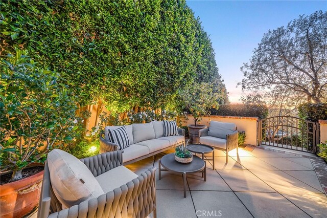 patio terrace at dusk featuring outdoor lounge area