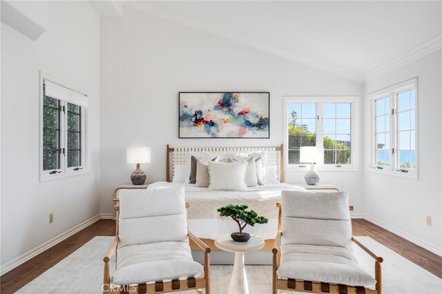 bedroom featuring lofted ceiling, hardwood / wood-style floors, crown molding, and multiple windows