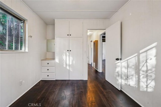 unfurnished bedroom with dark hardwood / wood-style flooring