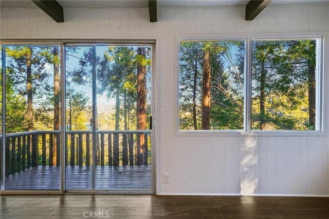 doorway featuring hardwood / wood-style flooring and beam ceiling