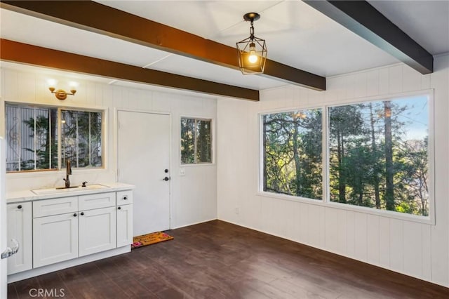 interior space featuring sink, dark hardwood / wood-style flooring, and beam ceiling