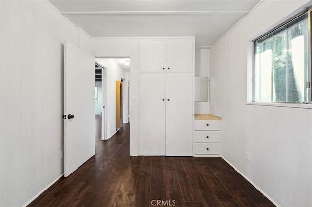 unfurnished bedroom with dark hardwood / wood-style floors