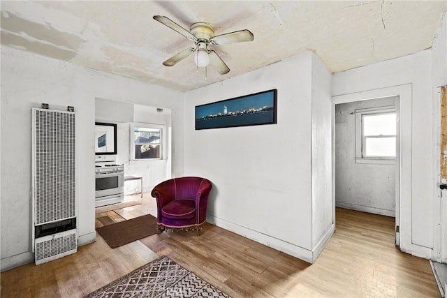 living area featuring ceiling fan and light hardwood / wood-style flooring