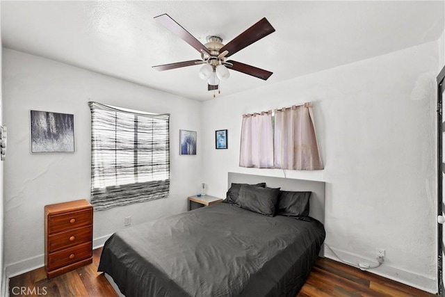 bedroom featuring dark hardwood / wood-style flooring and ceiling fan