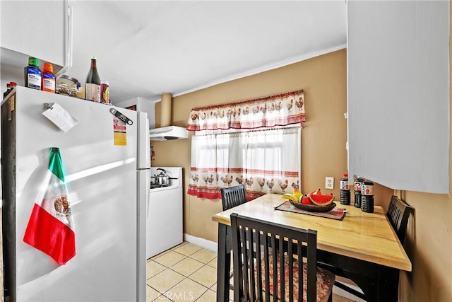 kitchen with white appliances and light tile patterned floors