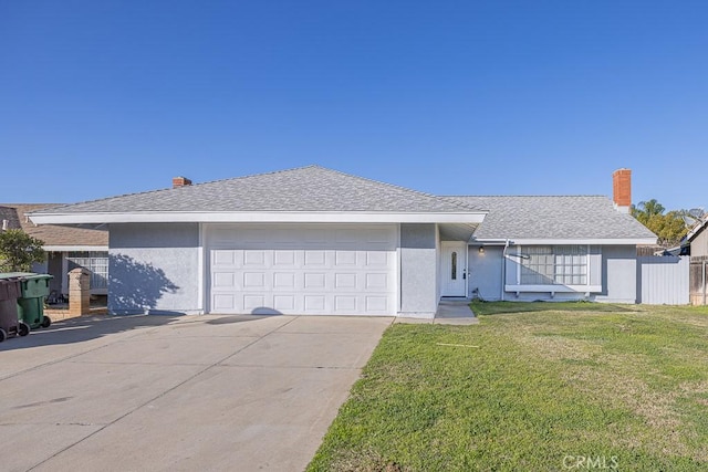 ranch-style house featuring a garage and a front lawn