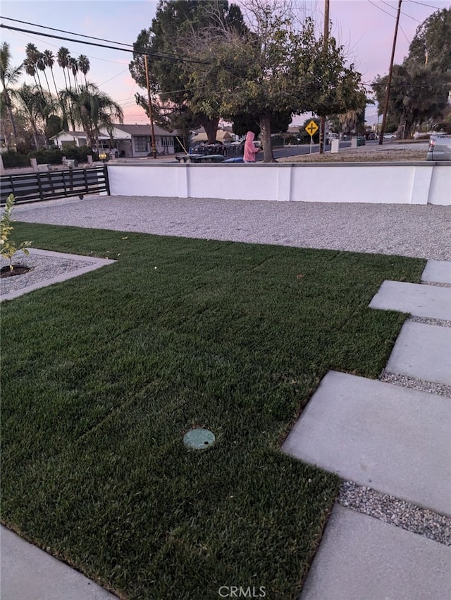 view of yard at dusk