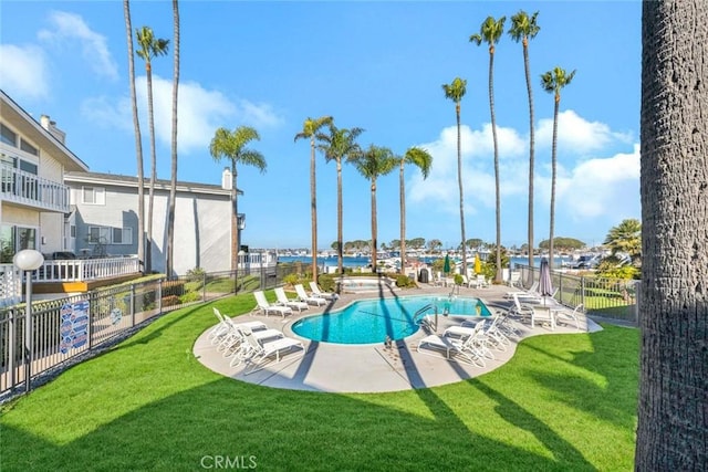 view of swimming pool featuring a patio and a yard