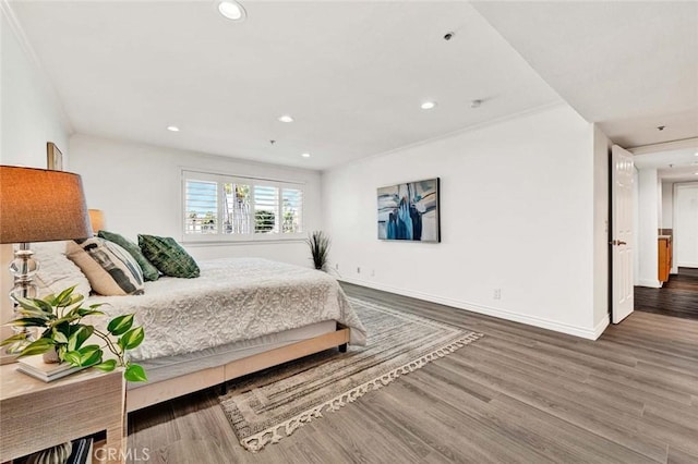 bedroom featuring hardwood / wood-style flooring and crown molding