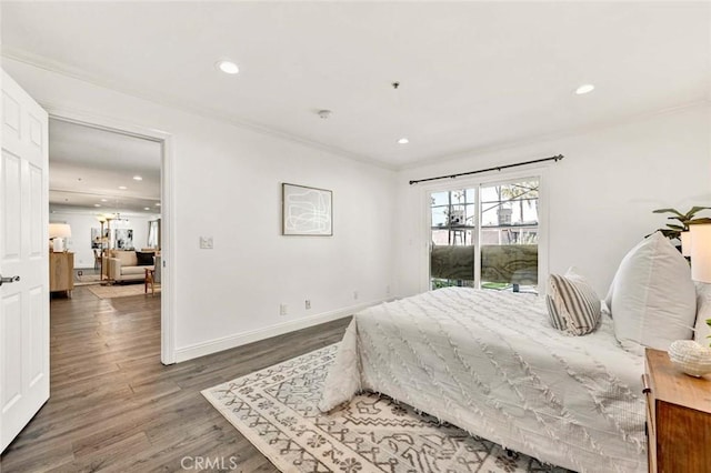 bedroom with dark wood-type flooring, crown molding, and access to outside