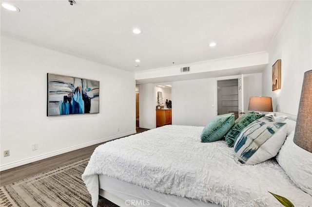 bedroom with dark wood-type flooring and crown molding