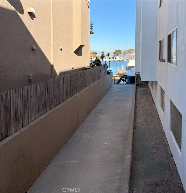 view of property exterior featuring a water view and a patio