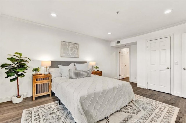 bedroom featuring dark hardwood / wood-style floors and ornamental molding