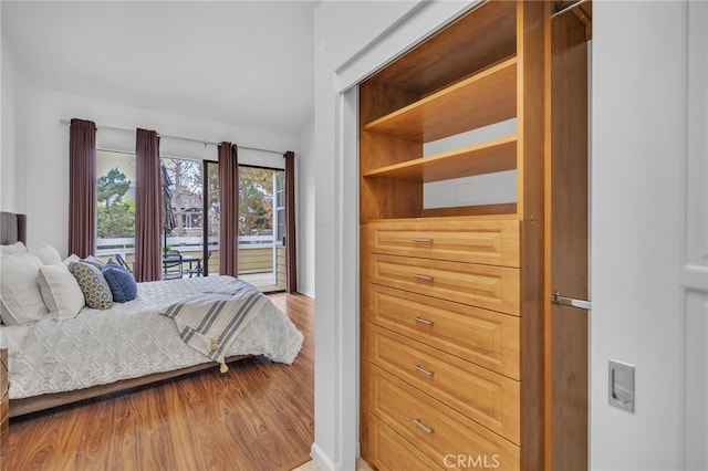 bedroom featuring hardwood / wood-style flooring and access to outside