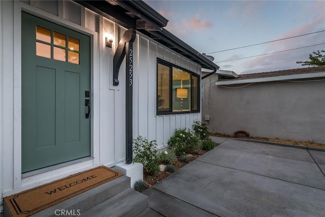 doorway to property featuring board and batten siding