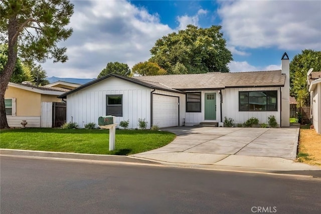 ranch-style home featuring a front lawn and a garage