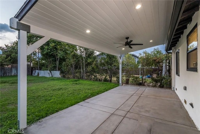 view of patio featuring a ceiling fan and fence