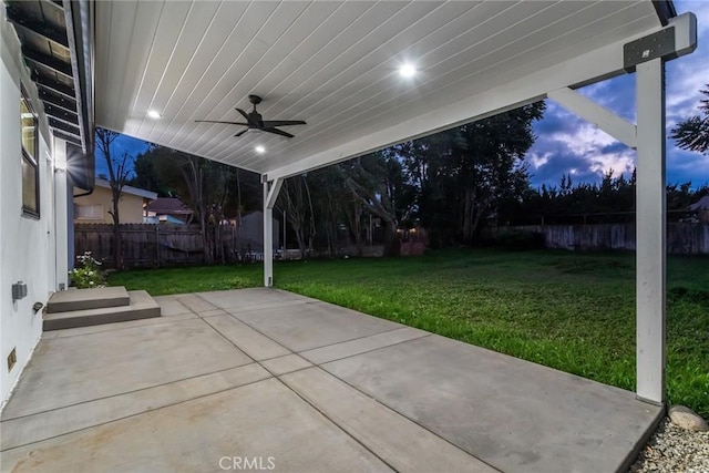 view of patio with fence and a ceiling fan