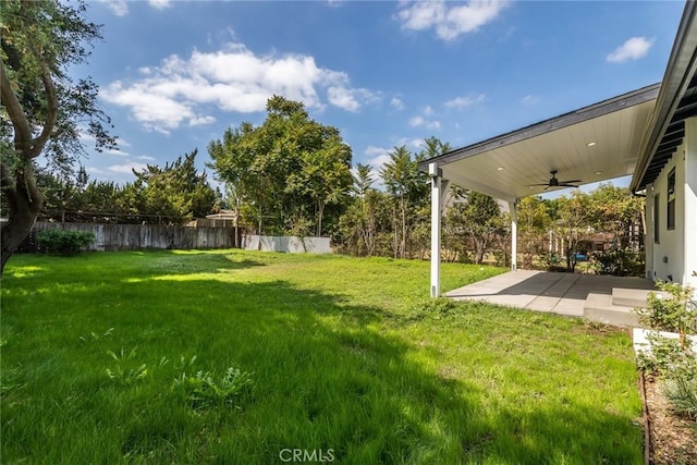 view of yard featuring a ceiling fan, fence, and a patio