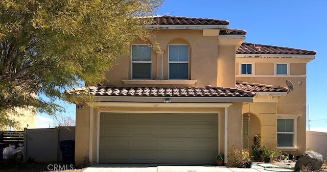 mediterranean / spanish-style house with a garage