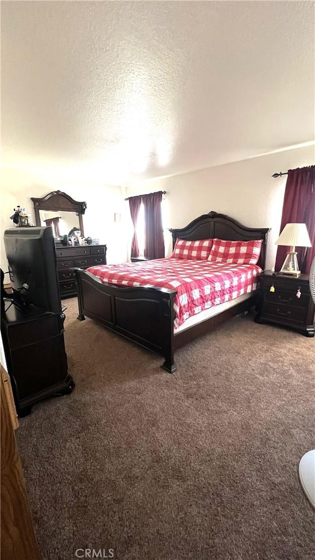 carpeted bedroom with a textured ceiling